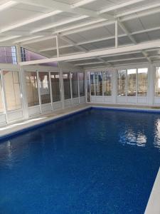 a large swimming pool with blue water in a building at Marija in Šibenik