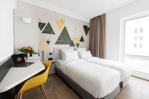 Rúm í herbergi á B&B HOTEL Oftringen
