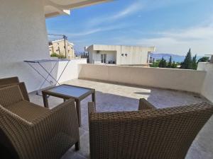 a patio with two chairs and a table on a balcony at Holiday Home Kalicanin in Bar