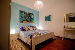 a bedroom with a bed with a painting on the wall at Da Stea guest house in Coreglia Ligure