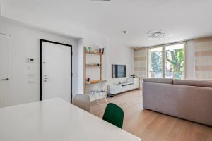 un soggiorno con divano e tavolo di Easylife - Modern and Spacious apt in Fiera City Life a Milano