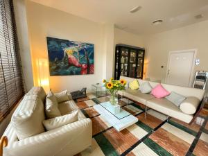 a living room with a couch and a vase of flowers at La Sort Boutique Hotel in Moraira