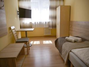 CKS Kraków (Centrum Konferencyjno-Szkoleniowe CS Natura Tour) tesisinde bir odada yatak veya yataklar