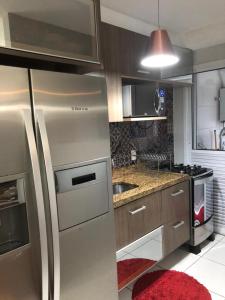 a kitchen with a stainless steel refrigerator and a stove at Allianz Parque , Perdizes in Sao Paulo