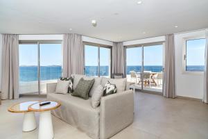 a living room with a couch and views of the ocean at Can Salia in San Antonio Bay