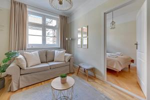 a living room with a couch and a bed at Downtown Apartments Old Town Powroźnicza in Gdańsk