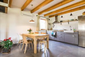 - une cuisine avec une table et des chaises en bois dans l'établissement Pr' Petrču, à Tolmin