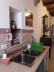 a kitchen with a sink and a counter top at Casa Profumo d' Estate in Pitigliano