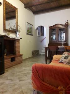 a living room with a bed and a fireplace at Casa Profumo d' Estate in Pitigliano