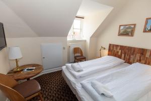 Voodi või voodid majutusasutuse Foldens Hotel toas