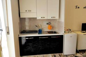 a small kitchen with a stove and a sink at Locazione Turistica La Primula in Turin