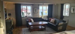 a living room with a couch and a coffee table at Sea Lodge Smögen in Smögen