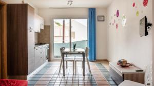 a small kitchen with a table and a window at Welcomely - Pan Di Zucchero - Nebida in Nebida