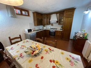 a kitchen with a table with a table cloth on it at Casa Ceragioli in Viareggio