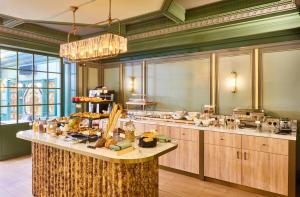 a buffet line with food on a table in a restaurant at Hotel Konti Bordeaux by HappyCulture in Bordeaux
