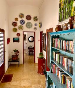 a hallway with two blue shelves filled with books at Charming Villa with Heated Pool near Sandy Beach, Hiking, Golf and Wineries in Luz