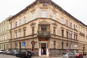 a large building on a street with cars parked outside at Artistic&Cozy in the Old Town in Krakow