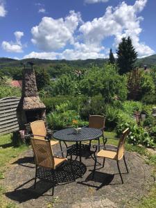 a patio with a table and chairs and a fireplace at Ferienwohnung Panoramablick in Rimbach