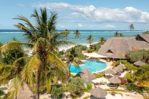 an aerial view of a resort with a swimming pool and the ocean at Zanzibar Queen Hotel in Matemwe