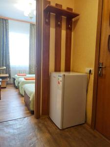 a room with a refrigerator and a row of beds at Гостевой дом Ася in Anapa