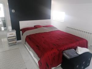 una camera da letto con un letto grande con una coperta rossa di Premium Two-bedroom Apartment a Viskovo