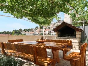 a wooden table and chairs on a patio at Holiday Home Ivo - MKA230 by Interhome in Brela