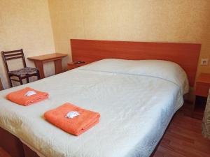 a bedroom with a bed with two towels on it at Гостевой дом Ася in Anapa