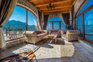 a living room with couches and large windows at VILLA MILENA in Kotor