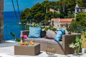 a patio with a couch and a view of the ocean at Villa Luigi with a pool in Cavtat