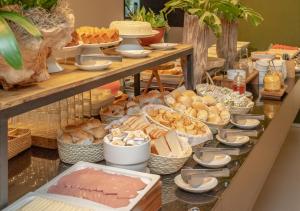 a buffet with different types of bread and other foods at Porto Kaeté Hotel in Maceió +13 photos