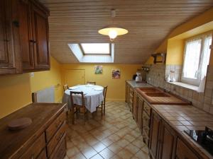 a kitchen with a table and a dining room at GITE LE PETIT SAUCELEY in Faymont