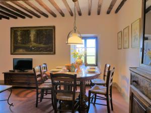 a dining room with a table and chairs at Apartment La Torre by Interhome in Podere Caminino +34 photos
