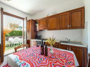 a kitchen with a table with a flowered table cloth at Apartment Leccio by Interhome in Preselle