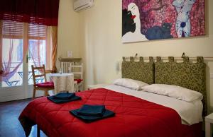 a bedroom with a red bed with towels on it at Ariel B&B in Verona
