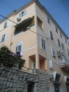 a tall building with a stone wall in front of it at Guesthouse Vrlic in Split