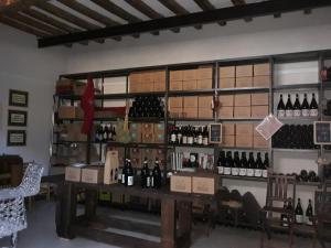 a room filled with lots of bottles of wine at WineBikeHostel in Rocca Grimalda