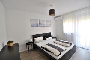 A bed or beds in a room at Best Apartman Lelle