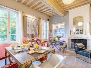 a kitchen and living room with a table and chairs at Hôtel La Suite in Villeneuve-lès-Avignon +15 photos
