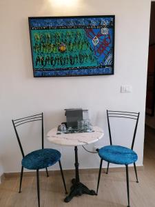a table with two chairs and a laptop on it at Casa Mosaico in Volterra