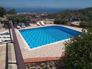 a swimming pool with a view of the ocean at Villa Oasi in Gaeta