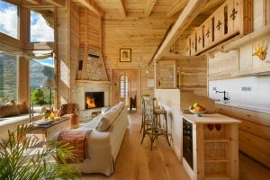 a log home kitchen and living room with a fireplace at Hotel Viñas de Lárrede in Lárrede