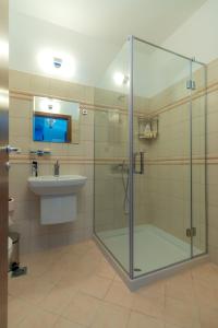a bathroom with a glass shower and a sink at Luxury 3-bedroom villa in Sozopolis with sea view in Sozopol
