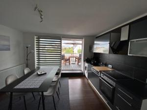 a kitchen with a table and a dining room at Henning 2 in Kirchdorf