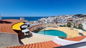 a view of a swimming pool on top of a building at Albufeira, One step to the beach (13) in Albufeira