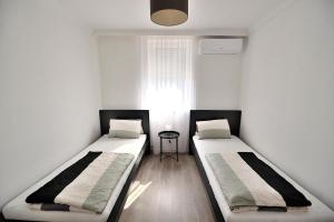 A bed or beds in a room at Best Apartman Lelle