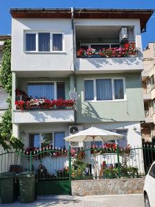 a building with an umbrella in front of it at Апартамент Върбанови in Pomorie