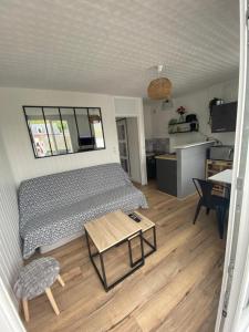 a room with a bed and a table and a kitchen at Détente en plein coeur du Tréport ! in Le Tréport