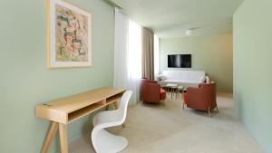 a room with a table and chairs and a dining room at BASKE VILLA in Martinske Hole
