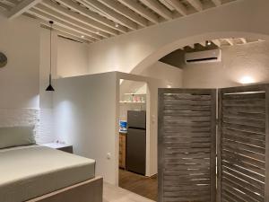a bedroom with a bed and a refrigerator at Rhodes Old Town Harmony Suite in Rhodes Town +32 photos