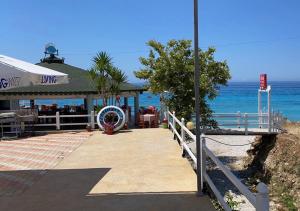 a restaurant on the beach next to the ocean at Villa John in Borsh